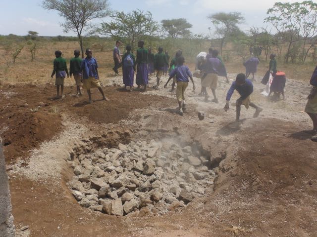 Filling the foundation for a tank using child labour!